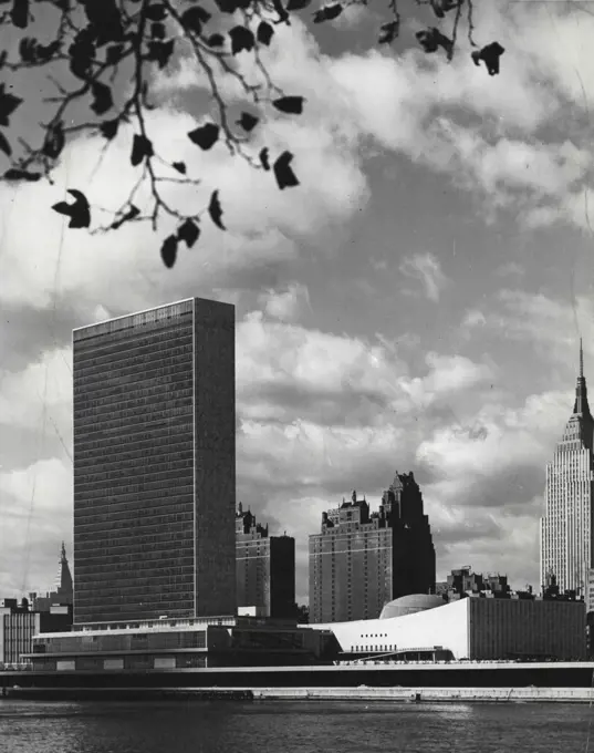 United Nations, New York -- The Headquarters of the United Nations and New York's mid-Manhattan skyline , as seen from the southern tip of Welfare Island, in the middle of the East River. The sky-scraper houses the Secretariat's offices; council chambers and conferences rooms are located in the low building at the river's edge and the General Assembly in the Homes building at right. This is the home of hope the whole world can identify at a glance ***** stark edifice that rises from the edge ***** New York's East River... modern as tomorrow.. It rests, it is said, on the ***** of Manhattan Island and on the most ***** and enduring dreams of man. October 24, 1955. (Photo by United Nations).