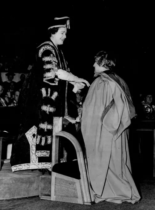 Queen Mother Confers Honorary Degree On Mrs. Pandit.
Queen Elizabeth the Queen Mother, who had just been installed as Chancellor of London University, confers the honorary degree of Doctor of Laws on Mrs. Vijaya Lakshmi Pandit, India's High Commissioner in London, at the Royal Festival Hall, London, today (Thursday).
The conferment of honorary degrees on Mrs. Pandit and a number of other distinguished persons followed the installation ceremony. November 24, 1955. (Photo by Reuterphoto).