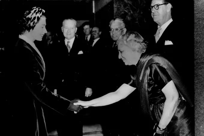 The Queen Meets Mrs. Pandit.
H.M. Queen-Elizabeth shaking hands with Mrs Pandit, India’s High Commissioner in London, when she attended a reception given by the Dominions Fellowship Trust at the Goldsmiths’ Hall, London. In background are seen Sir Thomas White, H.C. for Australia: Sir Claude Corea, Ceylon and Mr. J.P. Jooste, South Africa. March 16, 1955. (Photo by Sport & General Press Agency Limited).
