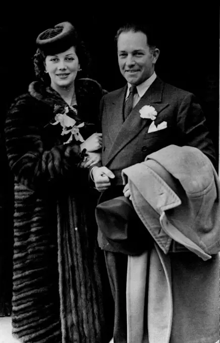 Well Known U.S. Flyer And Test Flyer Weds Paris Beauty.
The bride and bridegroom leaving the Southampton Registry office this afternoon.
Well known U.S. Flyer and Test pilot to Cunliffe-Owen Aircraft, Ltd was married to-day to Miss Swana Beaucaire Duval of Paris. The bridegroom was the first flyer to cross the Pacific Ocean on a non-stop flight. March 29, 1939. (Photo by Topical Press).