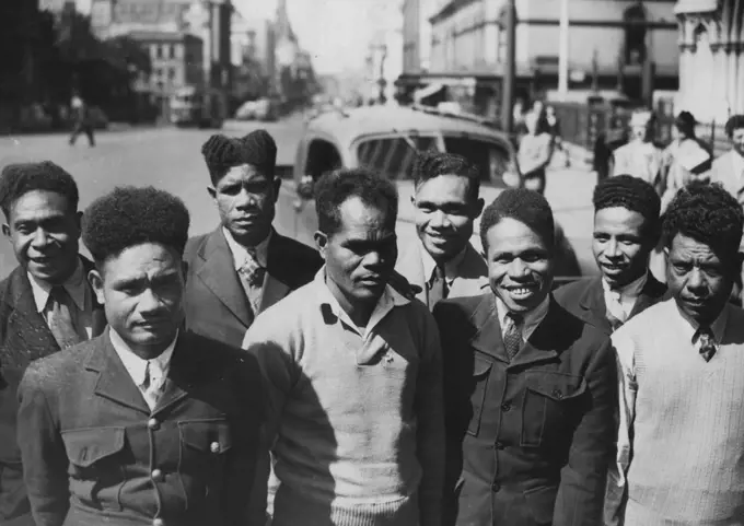 8 Papuan "Boys" See Town Today -- Eight Papuan "Boys", who arrived here by plane today, photographed in Elizabeth Street. They will form the crew of a lugger to be sailed to Port Moresby. October 15, 1947.