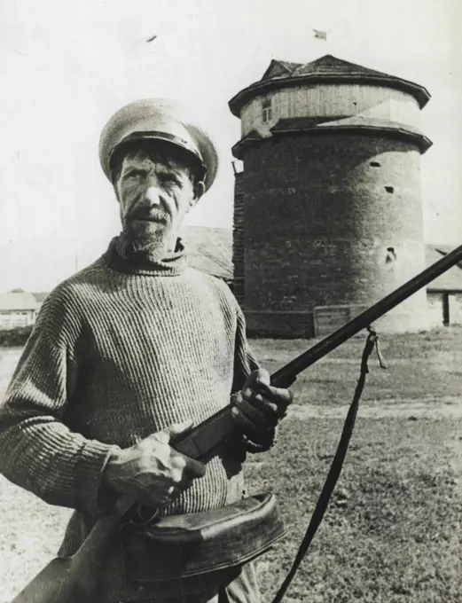 Collective Farmer On Guard -- A collective farmer stands guard with his rifle before a stable, according to Russian sources. May 11, 1941. (Photo by Associated Press Photo).