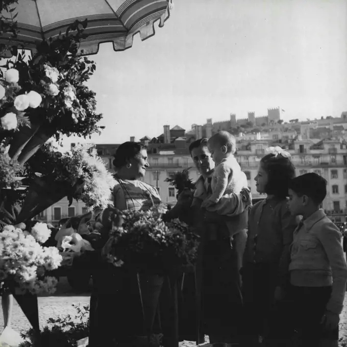 Lisbon 1952 -- The Castle of St. George, an old Moorish citadel, seen from the Lisbon flower market. February 27, 1952. (Photo by Sequeira, Camera Press).