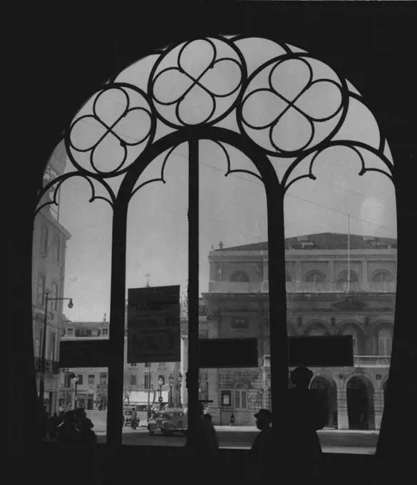 Cities of The World -- Lisbon -- Through the unique, architecture of the main entrance to Lisbon's Central Station, visitors can get this view of the National theater which faces the Plaza Rossio. April 22, 1955. (Photo by United Press).