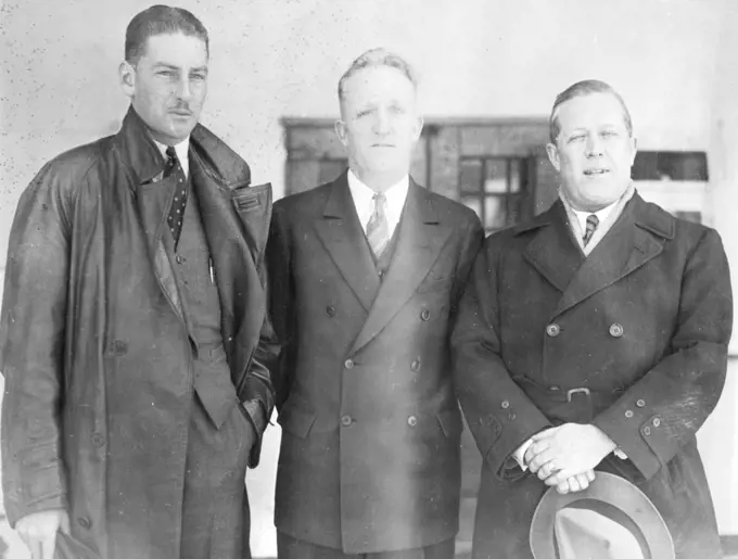 Pond May Enter Australian Race - Captain George Pond, shown here (right), as he arrived in New York Oct. 13 aboard the liner president Roosevelt, said he would look for a plane to enter in the London to Melbourne air race which starts Oct. 20. on the left is Warren Penny, a Sydney, Australia radio announcer, who will fly with him. Arthur Finch is in the centre, pond, who recently attempted a flight from harbor grace to Rome with Cesare Sabelli, said he might have to fly the Atlantic to reach London in time for the start of the race. October 13, 1934. (Photo by Associated Press Photo).