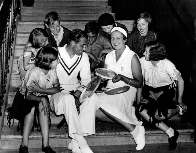 Tennis Enthusiasts.
Fred Perry and Betty Nuthall with youthful admirers when they took part in the Wimbledon 1934 episode in the Pageant of Parliament at the Albert Hall. August 27, 1934.