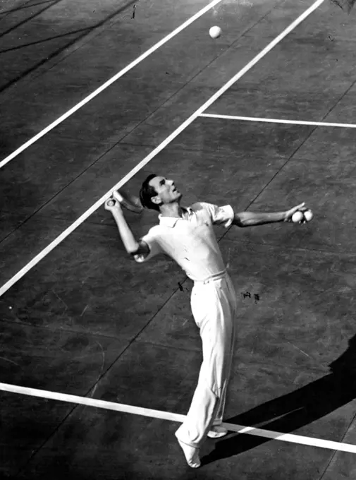 Perry Ousts Gledhill In Pro Tennis
Defending national professional Tennis champion Fred Perry (above) is shown serving to Keith Gledhill of Culver City in the Quarter-final match of the 1939 pro net title play at the Beverly Hills Tennis Club. Perry won by scores of 7-5, 5-7, 6-2. October 19, 1939. (Photo by ACME).