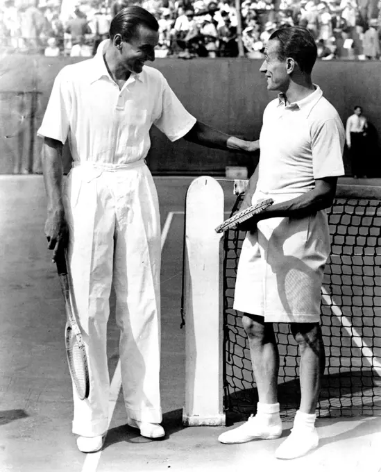 Perry Beats Cochet in Davis Cup.
Perry (left) joking with Cochet of France just before the start of their great match in the Davis Cup of the Final round this afternoon July 28 at the Stade Roland ***** in Paris. Perry won his match after a terrific battle with the Frenchman. September 05, 1933. (Photo by The Associated Press of Great Britain Ltd.).
