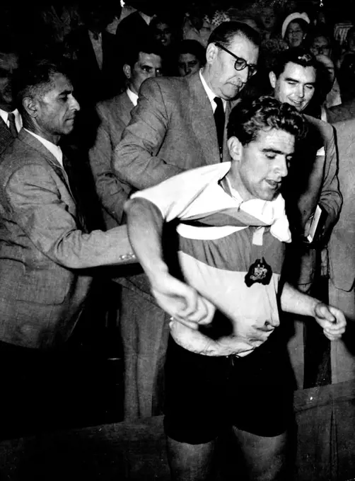 Australian cyclist Sid Patterson, dons the world champion's sweater after winning the world amateur pursuit title at Liege, Belgium. August 23, 1950.