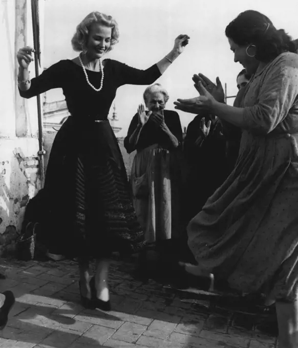 "Joan Finds Peace In Seville" -- All gypsies love dancing. So does £500-a-week singing star Joan Regan. And as the gypsies clapped their hands, Joan dances in old Seville. December 19, 1955. (Photo by Sunday Mirror).