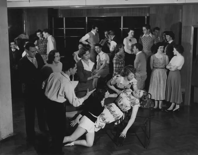 Rehearsal scene for forthcoming production.
Members, of the New South Wales Theatrical Society being coached by producer 'Regan for the pantomime, Sinbad, staged last October in Sydney. 
January 13, 1954.