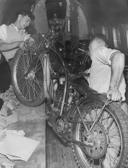 Air Cargo Charter worker G. Clayton (Left) and R. Smith coaching motorcycles on to the Lodester Aircraft which will fly them to Adelaide for the tests there. February 01, 1951.