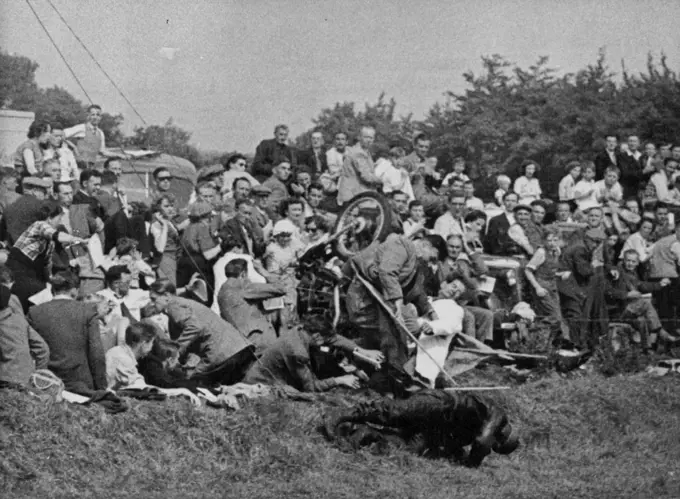 Motorcyclist Crashed into SpectatorsThe scene as A.R. Verity, riding an A.J.S., skidded into the crowd at coal hole corner during the Ulster Grand Prix over the Clady circuit in county Antrim, Northern Ireland, Aug 16. Verity is seen on the ground with his bike crashing into the crowed and a flag marshal being struck. None of the spectators was seriously injured. Verity was taken to hospital but released after treatment. September 03, 1952. (Photo by Associated Press Photo).