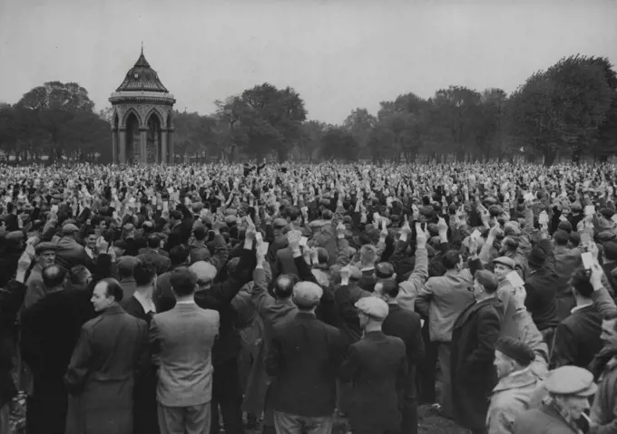 The Strike Goes On -- London Dockers at a meeting in Victoria Park, East London, today October 12, raise their hands to vote for the continuation of their nine-day-old strike. there are 26,000 men out. October 12, 1954. (Photo by Associated Press Photo).