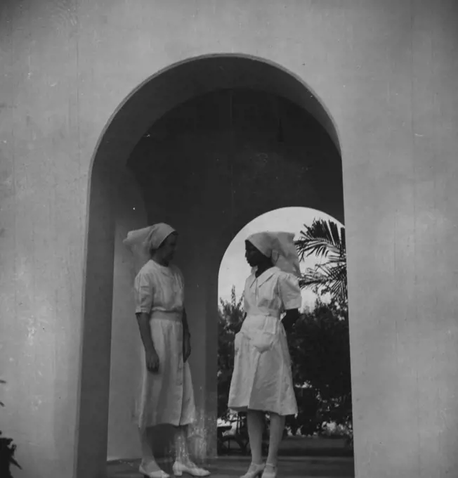 Sister Mary Rathna (right) trained in Bombay and an Indian Christian, talking to the Matron of the Hospital. September 19, 1951. (Photo by British Official Photograph).