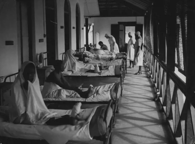 Zanzibar Hospital -- Matron on her daily tour of inspection of wards. She stops in the woman's ward to ask how the patients are this morning. September 01, 1951. (Photo by British Official Photograph).