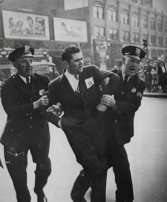 Phone Picket Seized -- Russell Bridge, President of Local 65, Association of Communications and equipment worker is seized by police after a picket line argument as installers and maintenance men renewed picketing of some New Jersey phone exchange because of a still unsettled dispute. June 04, 1947. (Photo by AP Wirephoto).