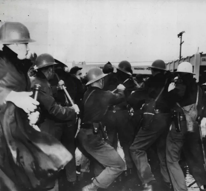 Deputies Drive Back Film Demonstrators -- Deputy sheriffs and police officers Drive Back paraders who demonstrated at Metro Goldwyn-Mayer studio today and engaged the officers in a battle which resulted in a dozen arrests and injuries to a number of participants on both sides. December 1, 1946. (Photo by AP Wirephoto).