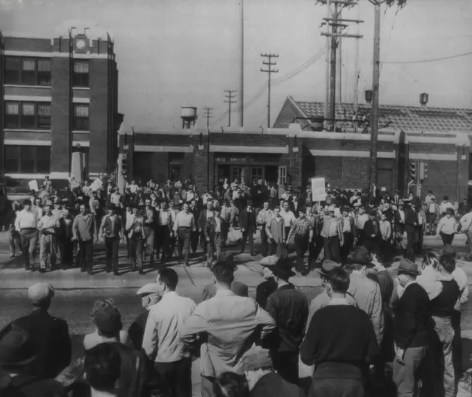 Refinery Employees Walk Out -- Worker walk out of the Sinclair Refining Co., yesterday, joining other plant workers (foreground) in a walkout to enforce demands for a 30% wage increase. September 20, 1945. (Photo by AP Wirephoto).