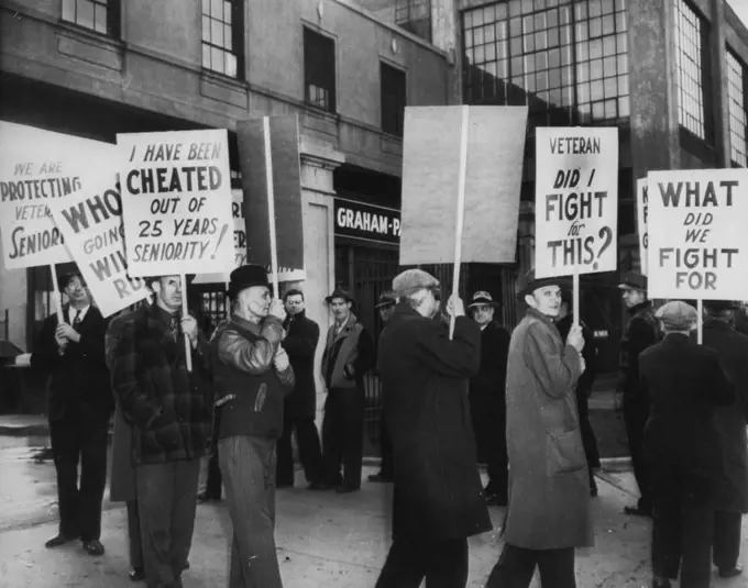 Auto Production At Willow Run Delayed: Graham-Paige Motors Corp. Employees picket the Auto plant today demanding assurance that seniority rights be protected when the transfer of operations to Willow Run is completed. The Bomber plant has been leased for production of the Frazer and Kaiser automobiles. November 26, 1945. (Photo by AP Wirephoto).