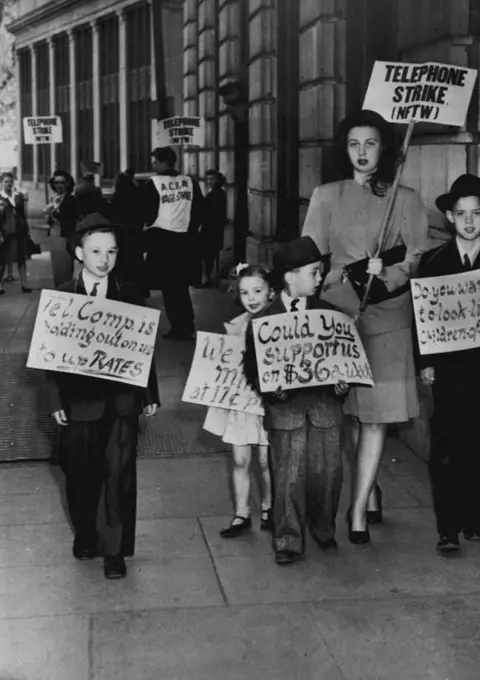 Kids Join Mom On Picket Line -- Pretty Mrs. Gery LaBaugh, 27, is joined by her children as she walks in picket line fore telephone exchange here. April 13, 1947. (Photo by AP Wirephoto).