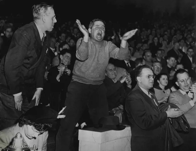 Striker Shouts Against Settlement - A worker of the Philadelphia Transportation company shouts against settling the transit strike here early today during a mass meeting of strikers after negotiators had reached agreement in the ten-day strike. Other strikers applaud or shout during the stormy session. February 20, 1949. (Photo by AP Wirephoto).