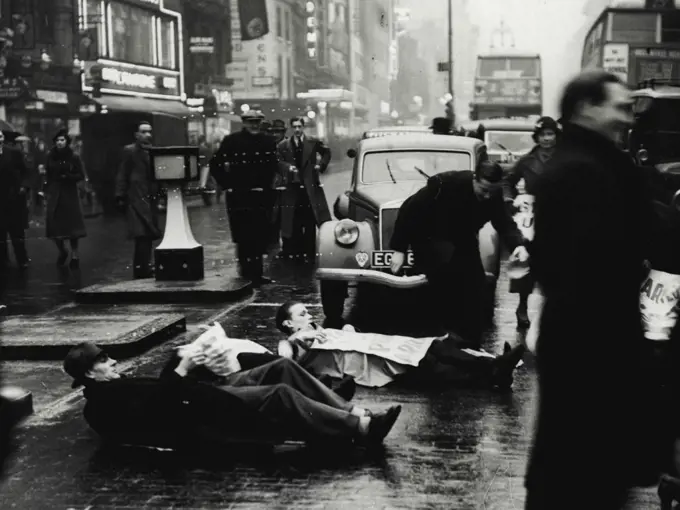 Unemployed Men Lie Down in Oxford Street -- The unemployed men lying in the road at the corner of Oxford Street and Berwick Street.Members of the Unemployed Workers Movement staged another demonstration today when they laid down in the road at the corner of Oxford Street and Berwick Street, Holding up the traffic until the police dispersed them. January 17, 1939. (Photo by Keystone Press Agency Ltd.).