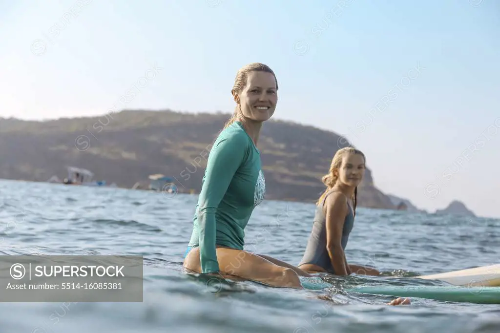 Young female surfers on surfboard