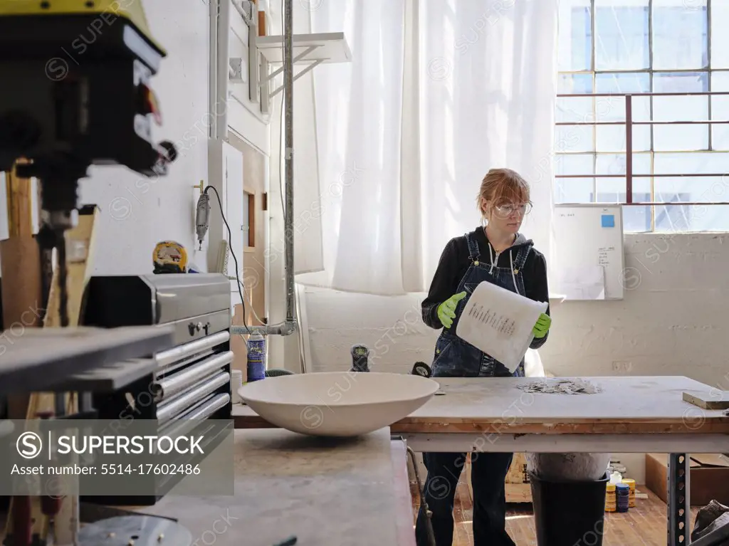 Professional female sculptor working in her studio