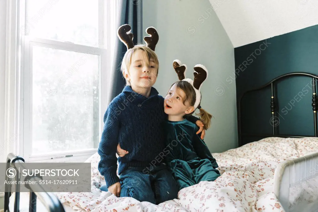 Two children talking about Christmas in their room