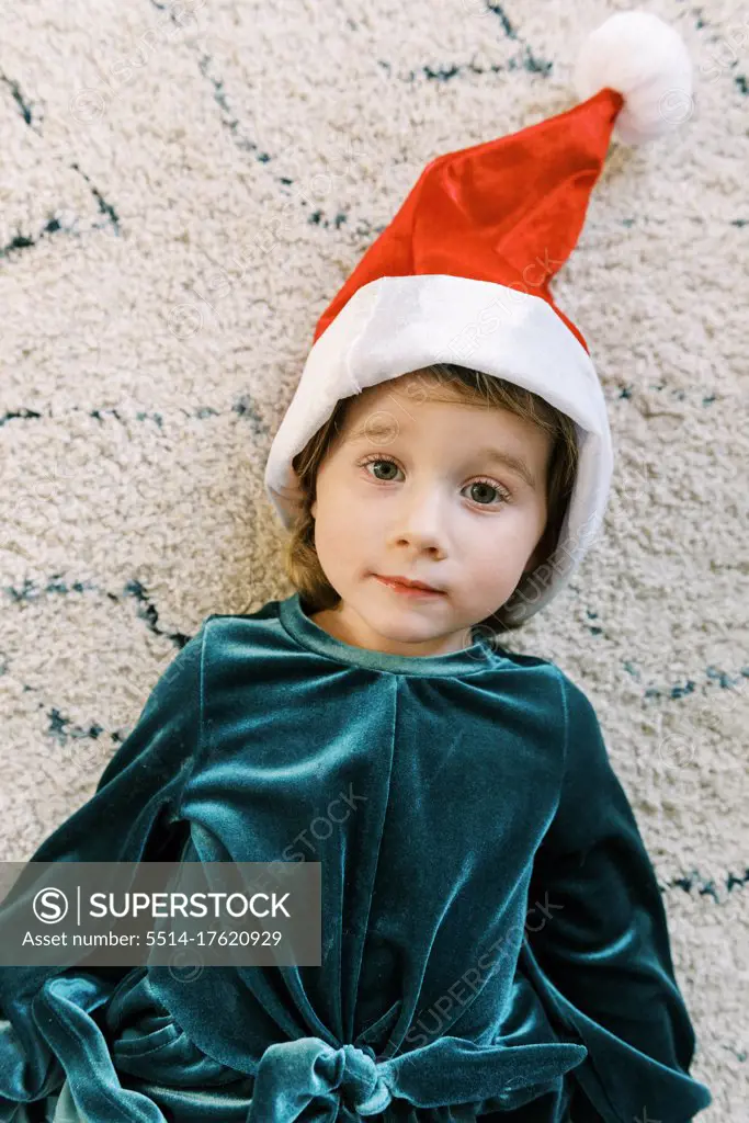 A little girl dressed up like a Christmas elf