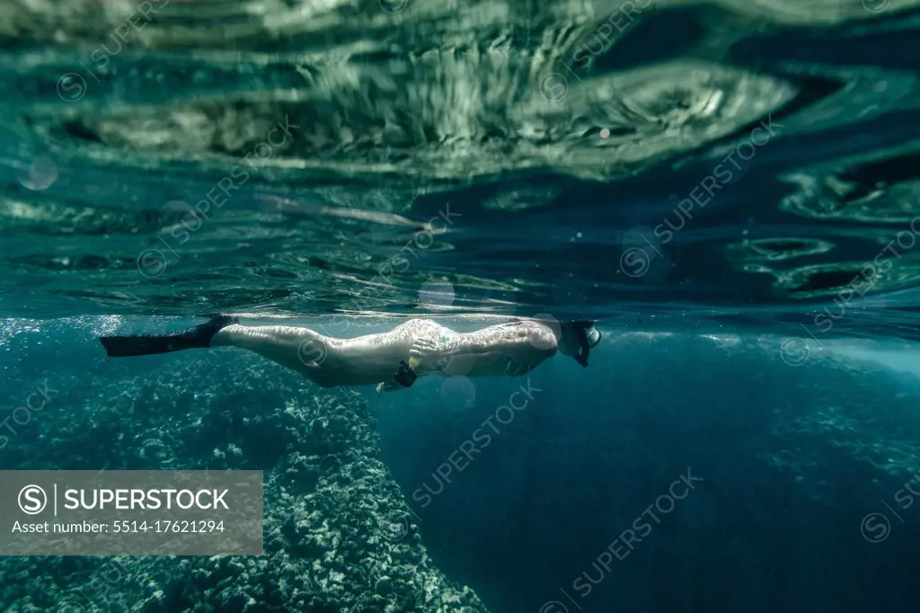 Adult Female snorkeling in clear water in hawaii