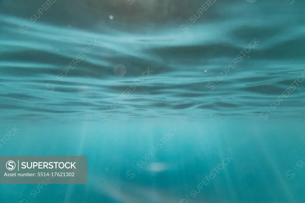 light streaks and textures underneath the ocean's surface in hawaii