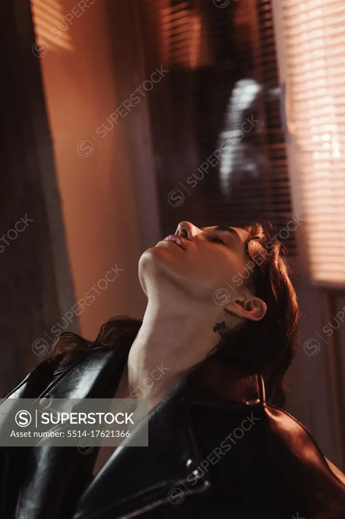 Woman in leather resting on a chair