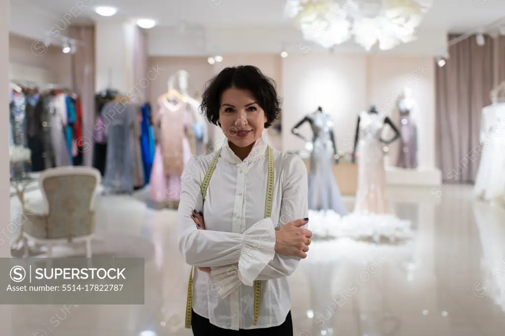 Successful female owner of fashion boutique looking at camera