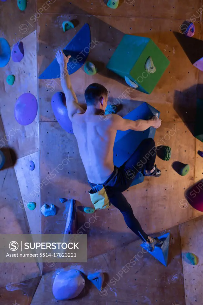 Unrecognizable boulderer on climbing wall