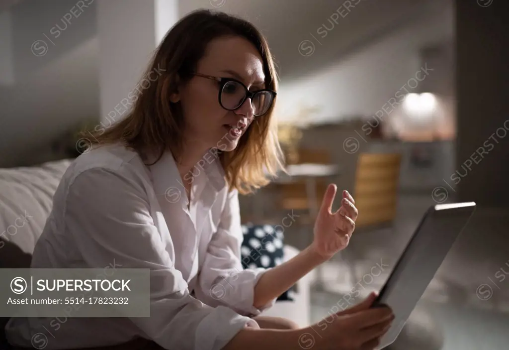 Professional businesswoman with tablet working at home