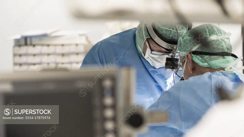 two surgeons in the operating room during surgery