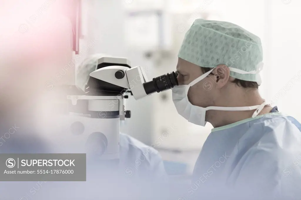 an ophthalmologist operates with a microscope