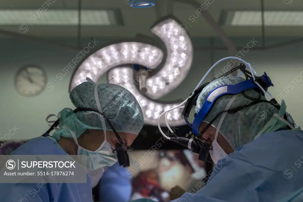 two cardiac surgeons operating on a patient