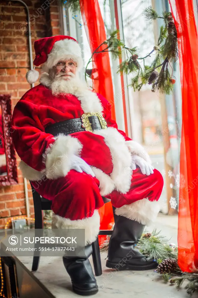 Santa sitting in window display