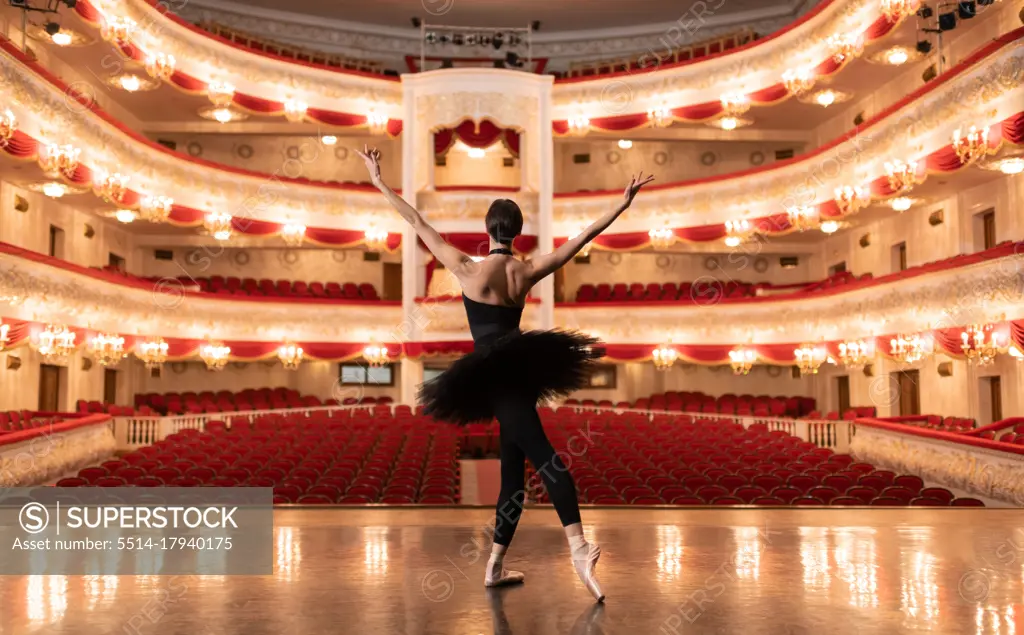 Anonymous ballerina finishing performance in empty theater