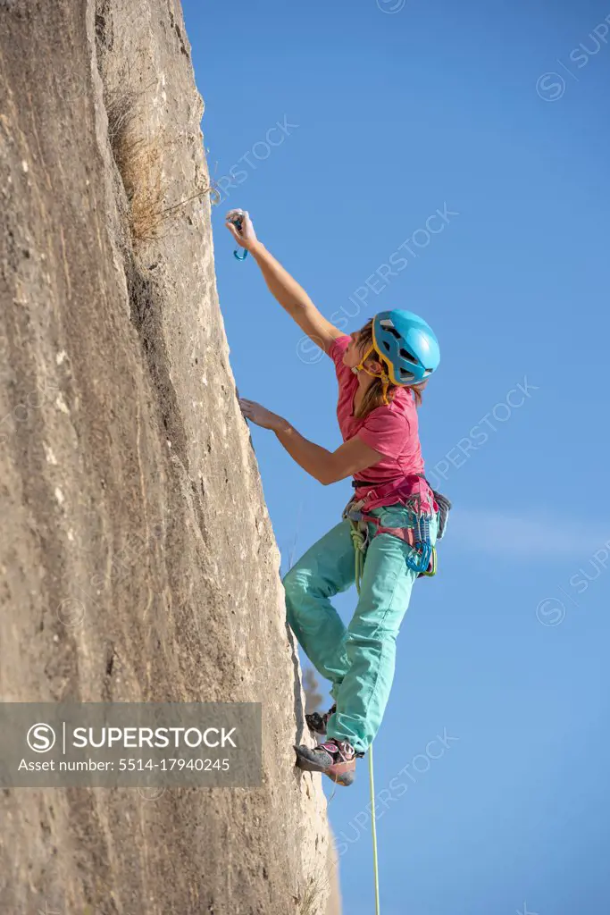 Female rock climber in Toix Est, Calpe, Costa Blanca, Alicante Province, Spain