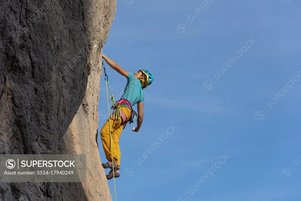 Female rock climber in  Olta mountain, Calpe, Costa Blanca, Alicante Province, Spain
