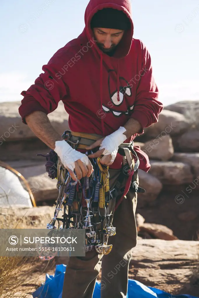 Man with climbing equipment on cliff at Canyonlands National Park