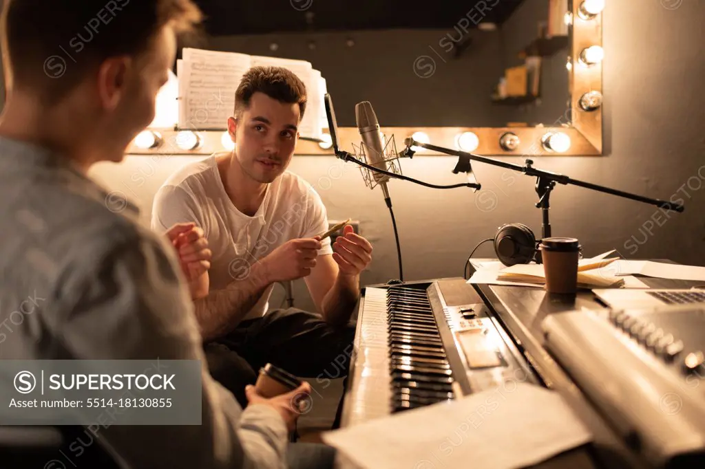 Musicians talking during break in studio