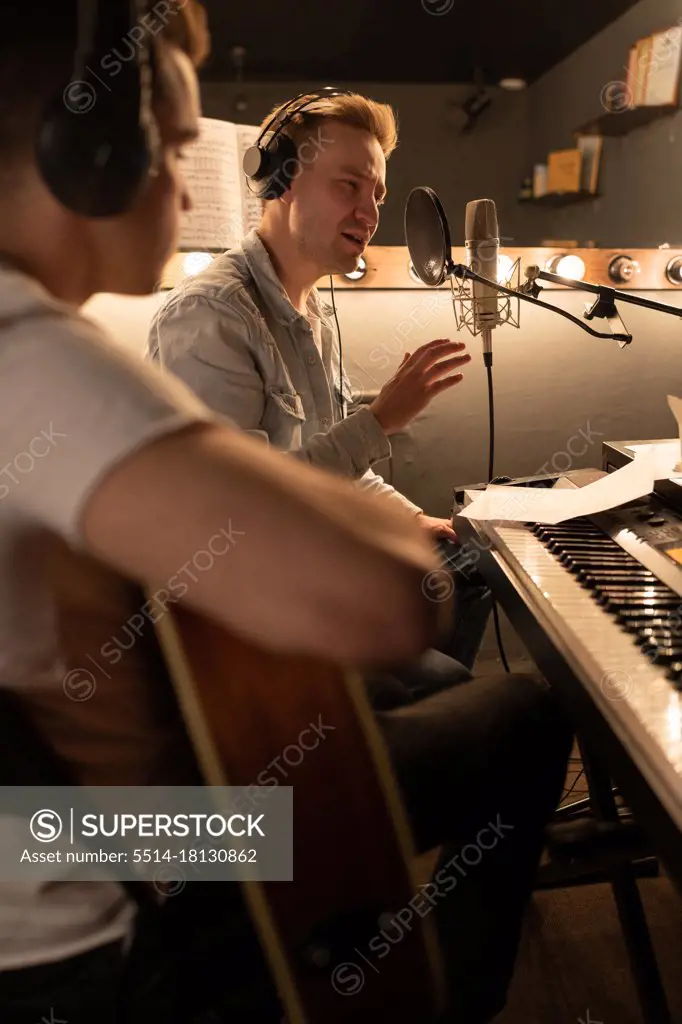 Professional musicians creating song in recording studio