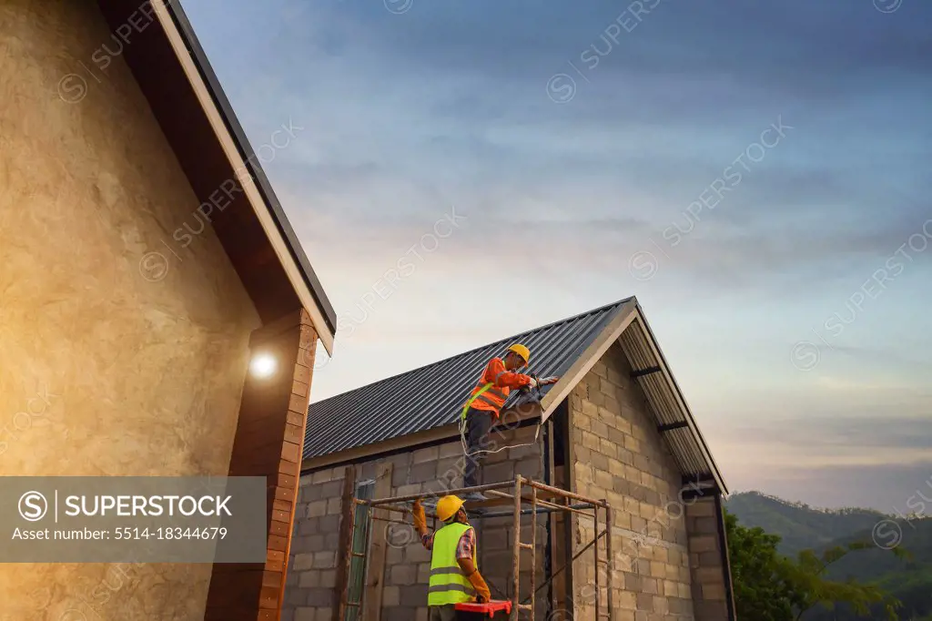 Construction worker install new roof