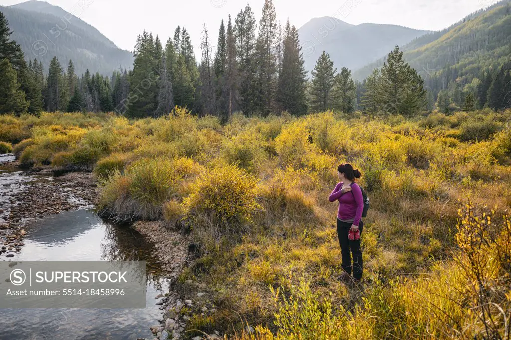 Woman standing near a creek in the Eagles Nest Wilderness, Colorado