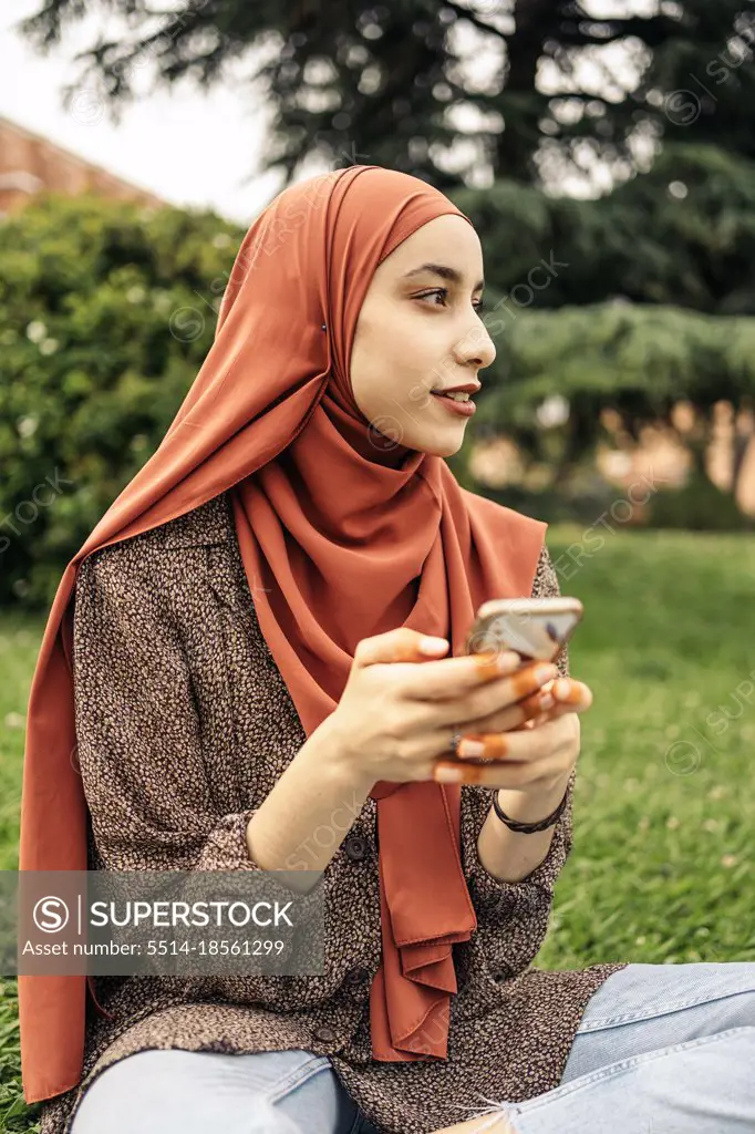 Muslim woman using a phone